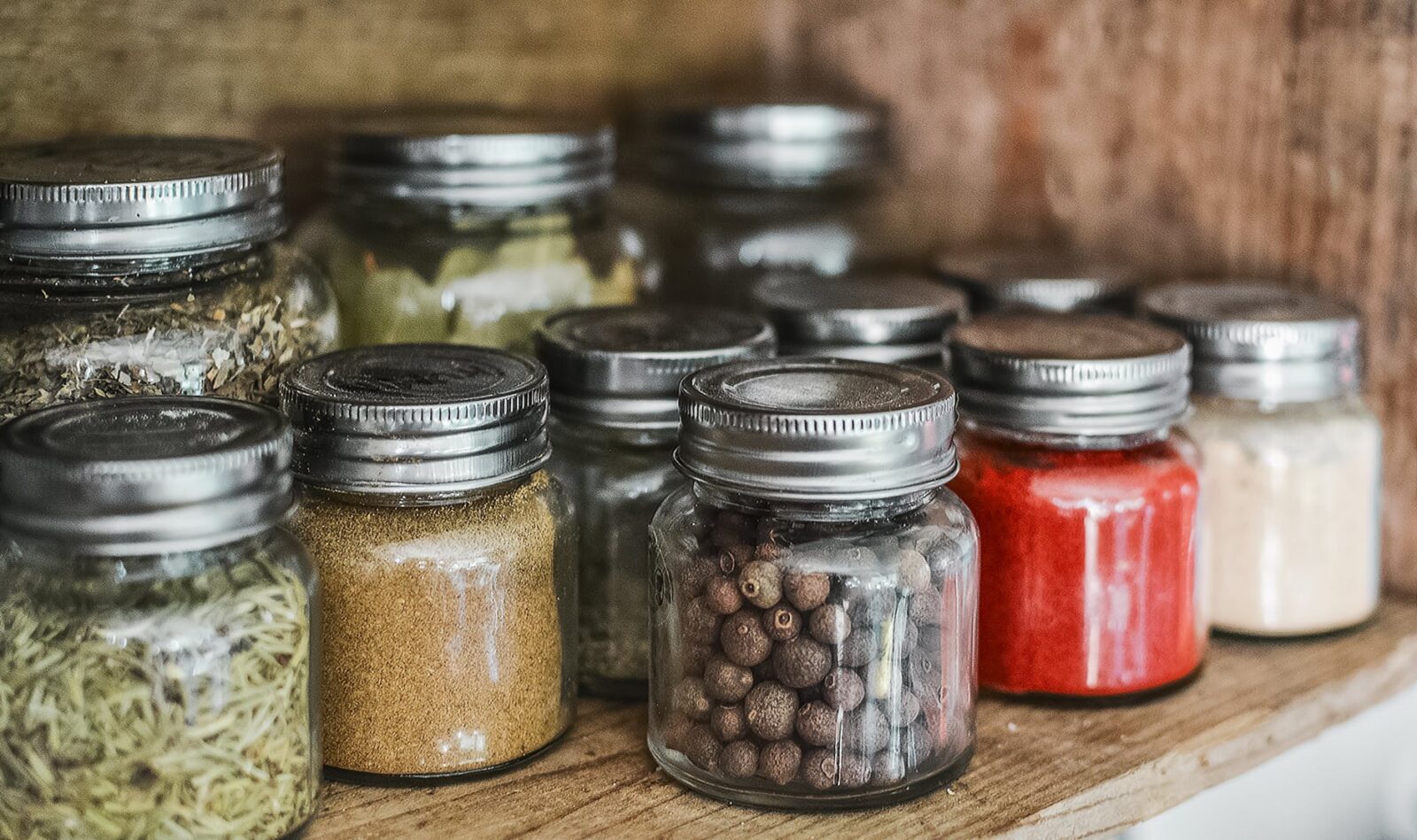Glass mason jars of dried herbs and spices