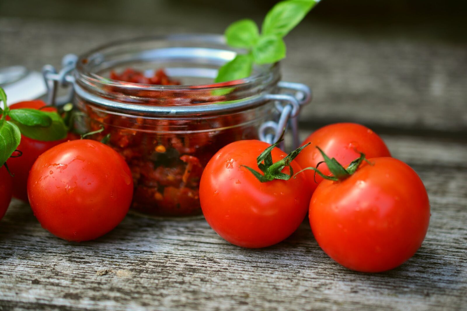 Sundried tomatoes and basil in glass jar 8 Ways to Preserve Your Harvest