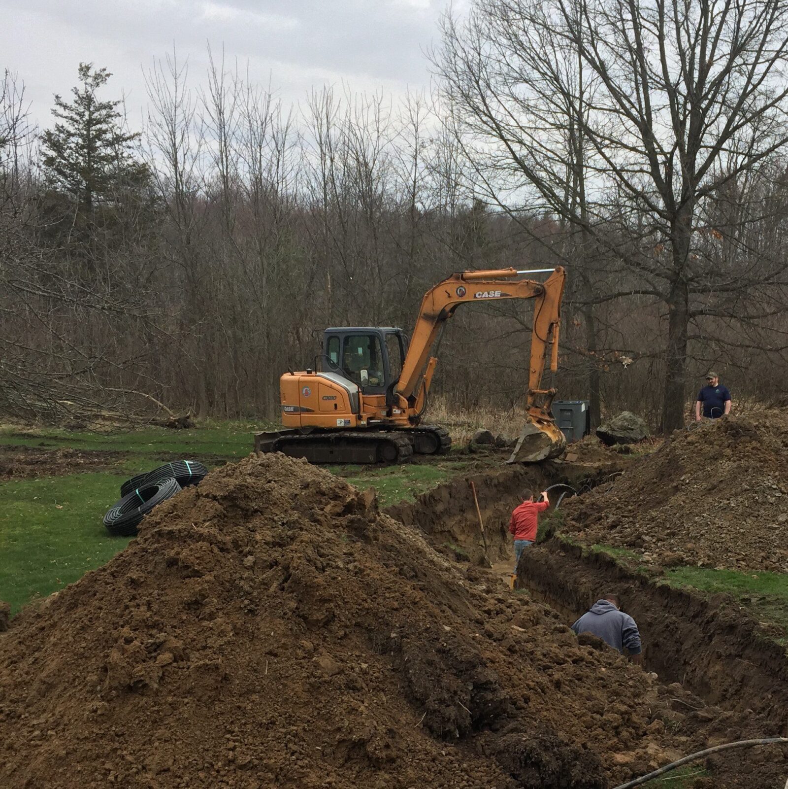 Backhoe digging geothermal trench