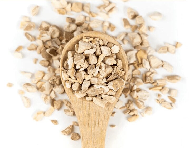 A wooden spoon filled with dried, crushed roots arranged on a white background. Happy Tea: Uplifting Herbs for the Winter Blues