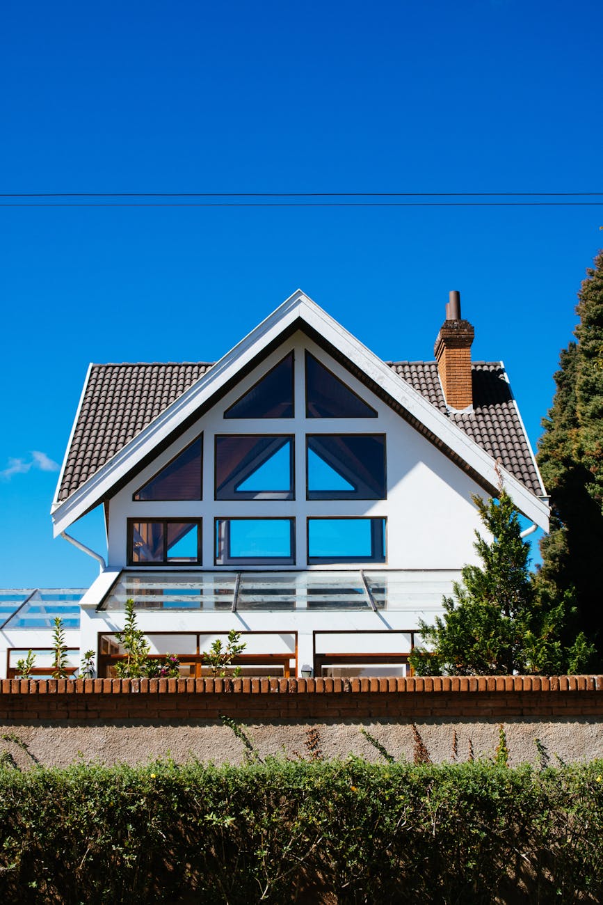 white concrete house under clear blue sky Blog Article Categories Real Estate