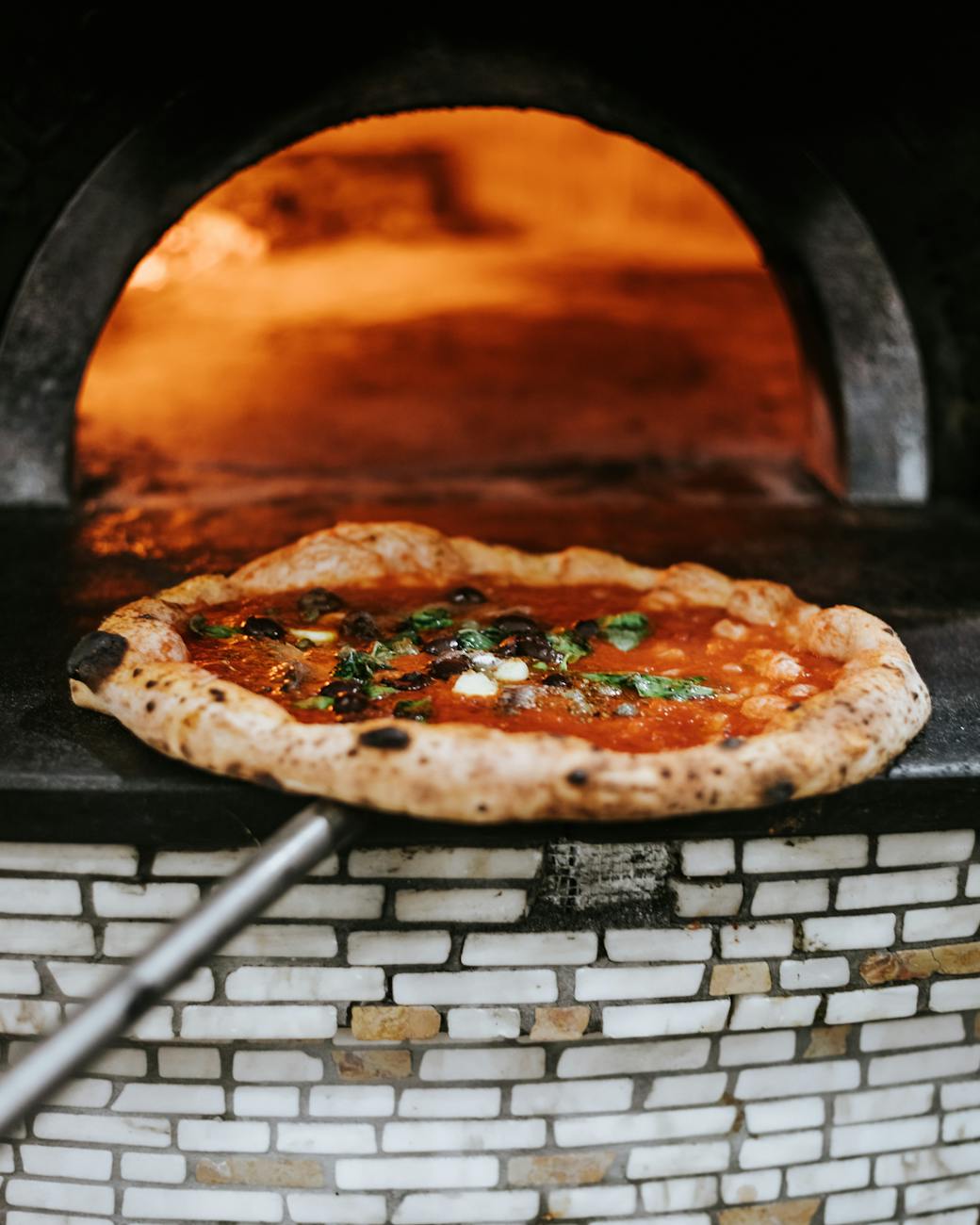 a pizza taken from an oven