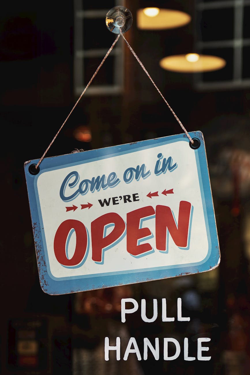 white and blue come on in we ere open signage Should you invest in a commercial property or rent?