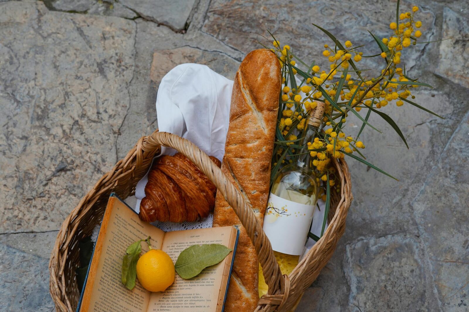 rustic french picnic basket with bread and wine 10 Ways to Prep Your Vacation Rental Property for Guests