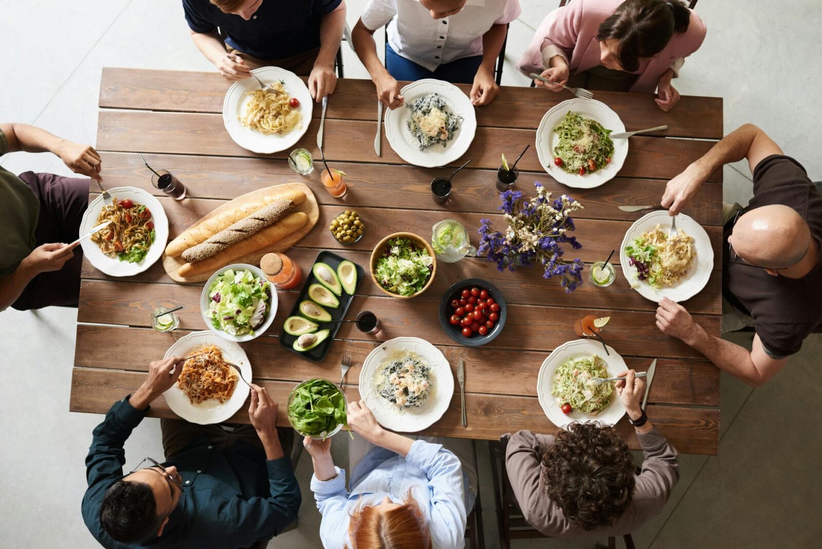 group of people eating together hygge home design ideas to feed your mental health