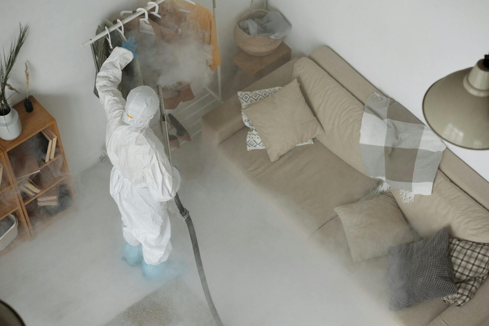 a man wearing white protective clothing fumigating clothes Urgent Home Repair Warning Signs You Shouldn’t Ignore