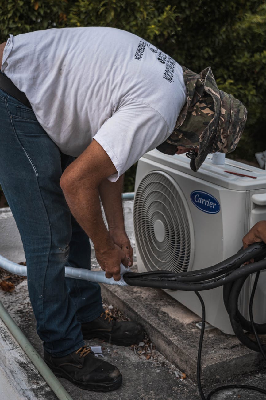 man taping a hose Urgent Home Repair Warning Signs You Shouldn’t Ignore