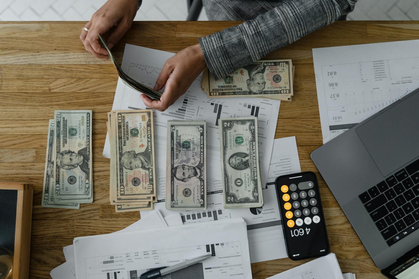 a person arranging cash money on wooden table The Ultimate Guide to Financial Independence