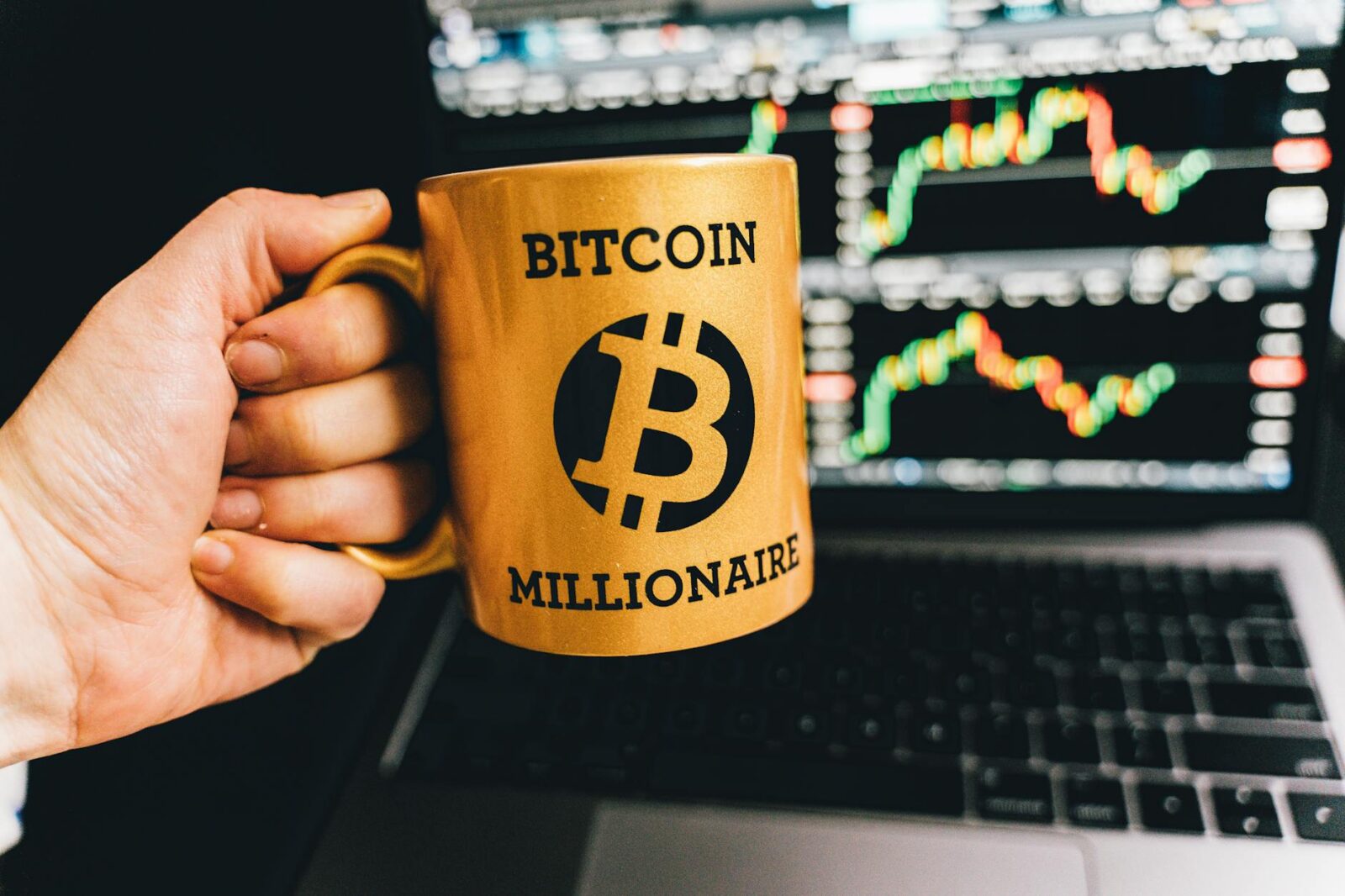 a person holding a mug The Ultimate Guide to Financial Independence