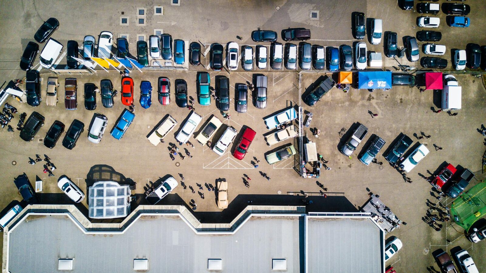 high angle photo of vehicles parked near building Should you invest in a commercial property or rent?