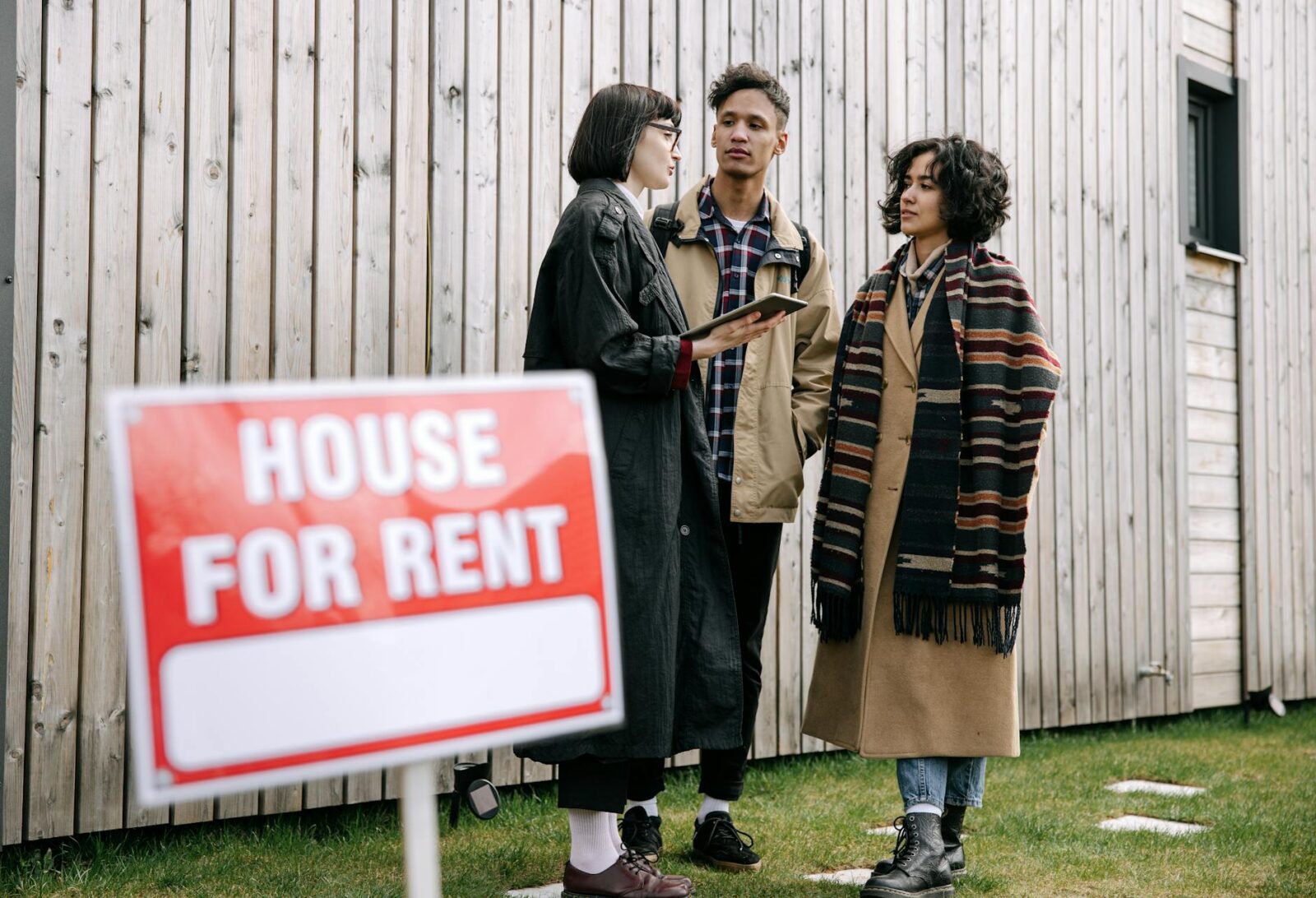interracial couple talking to real estate agent How to Handle a Landlord Dispute with Your Tenant