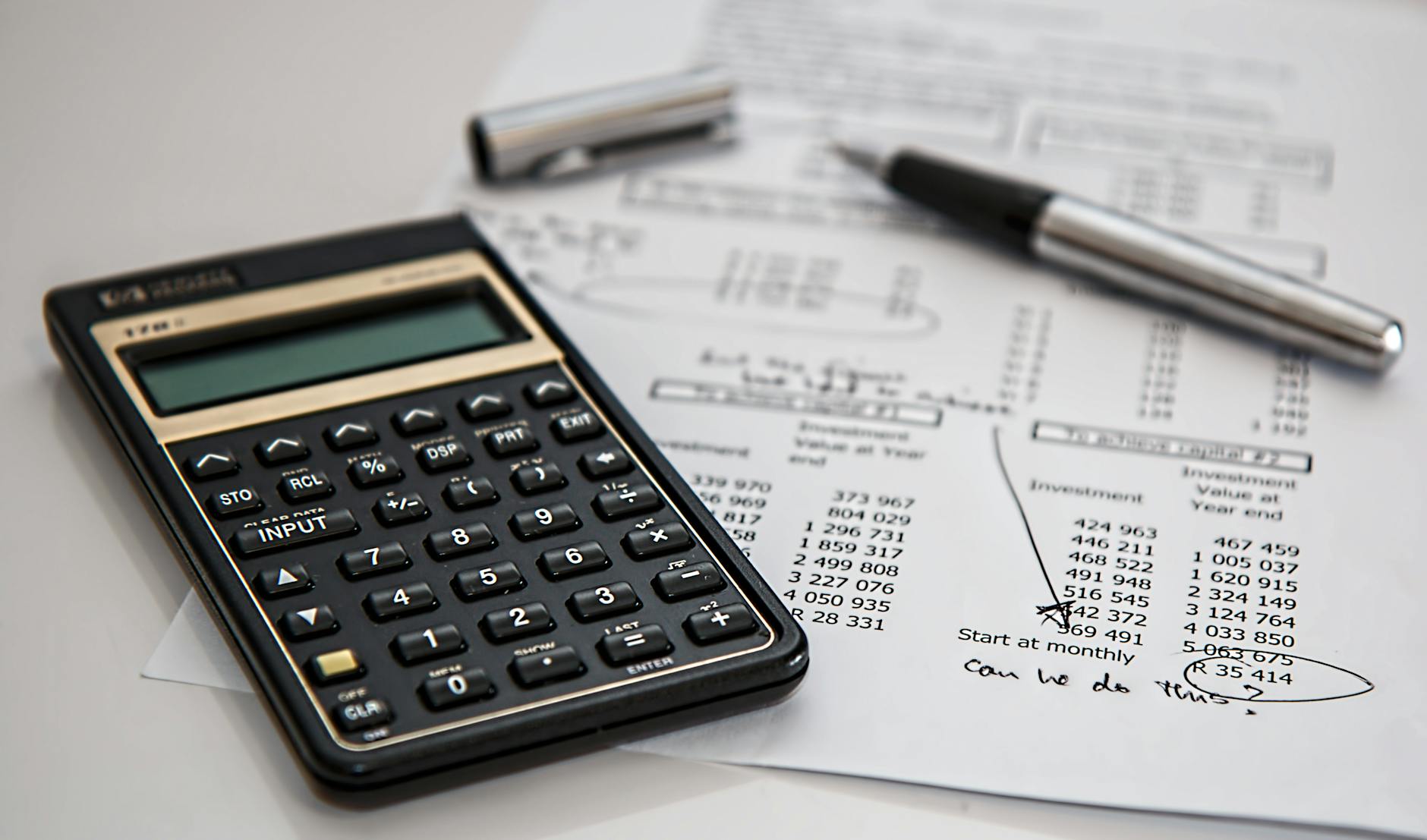 black calculator near ballpoint pen on white printed paper 6 Real Estate Metrics All Pro Investors Track