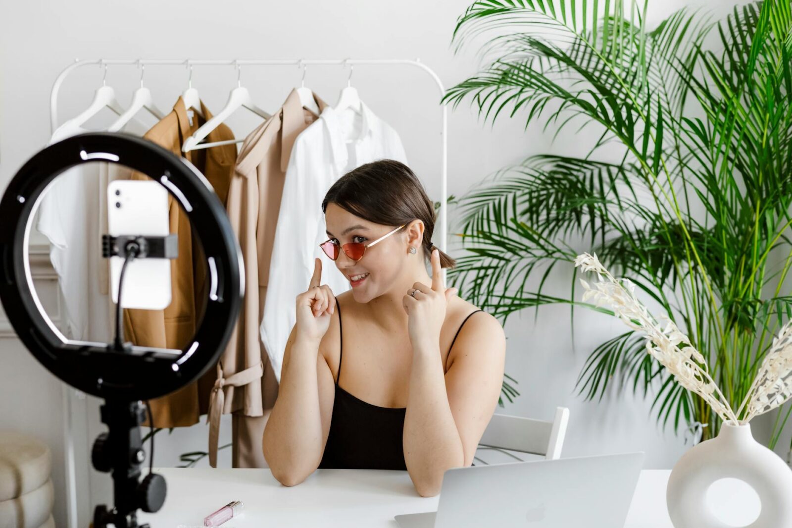 a woman showing her sunglasses to a video recording How to Do Influencer Marketing Like a Pro: Crush the Game and Build Your Brand