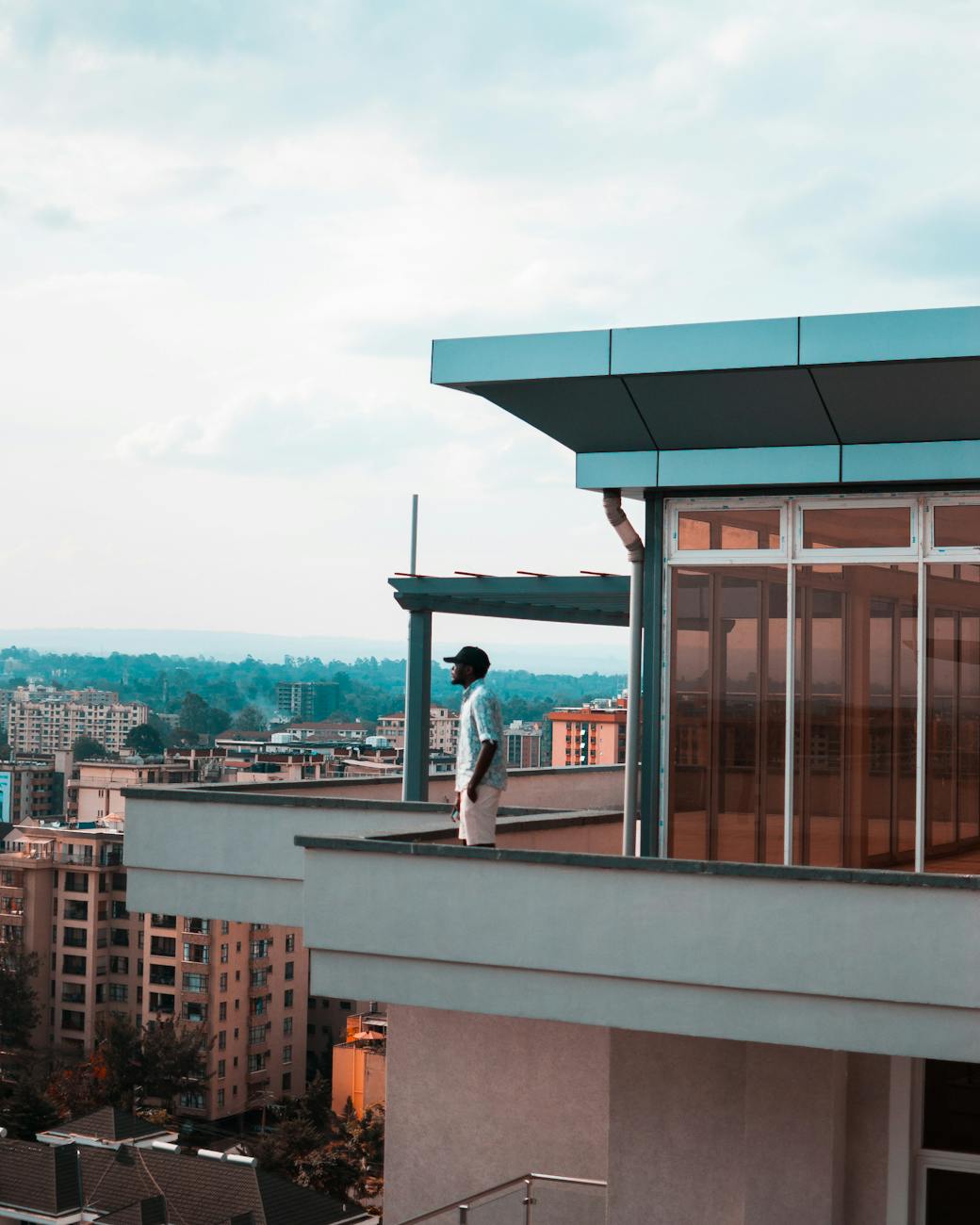 man standing on balcony How to Choose the Perfect Location to Invest in Real Estate