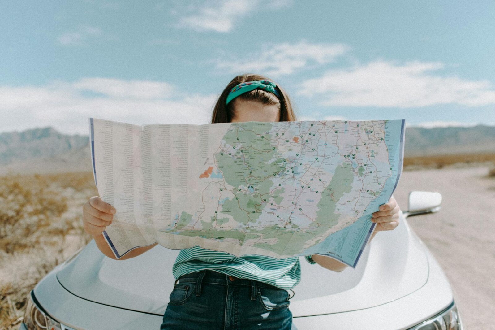 woman looking at the map How to Choose the Perfect Location to Invest in Real Estate