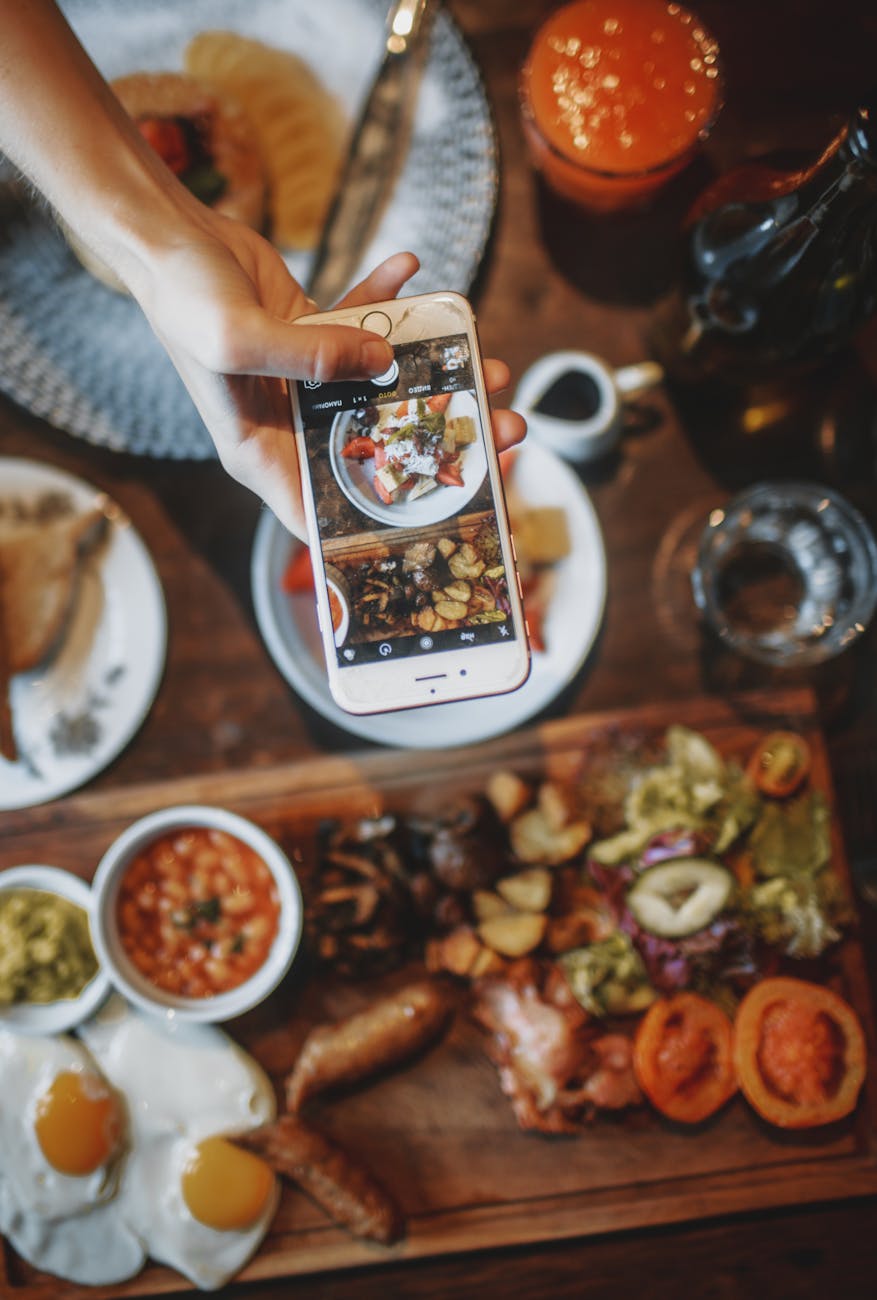 crop person taking photo of delicious breakfast How to Do Influencer Marketing Like a Pro: Crush the Game and Build Your Brand