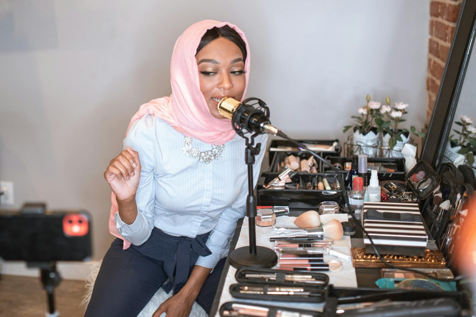 female vlogger in pink hijab using a condenser microphone How to Do Influencer Marketing Like a Pro: Crush the Game and Build Your Brand