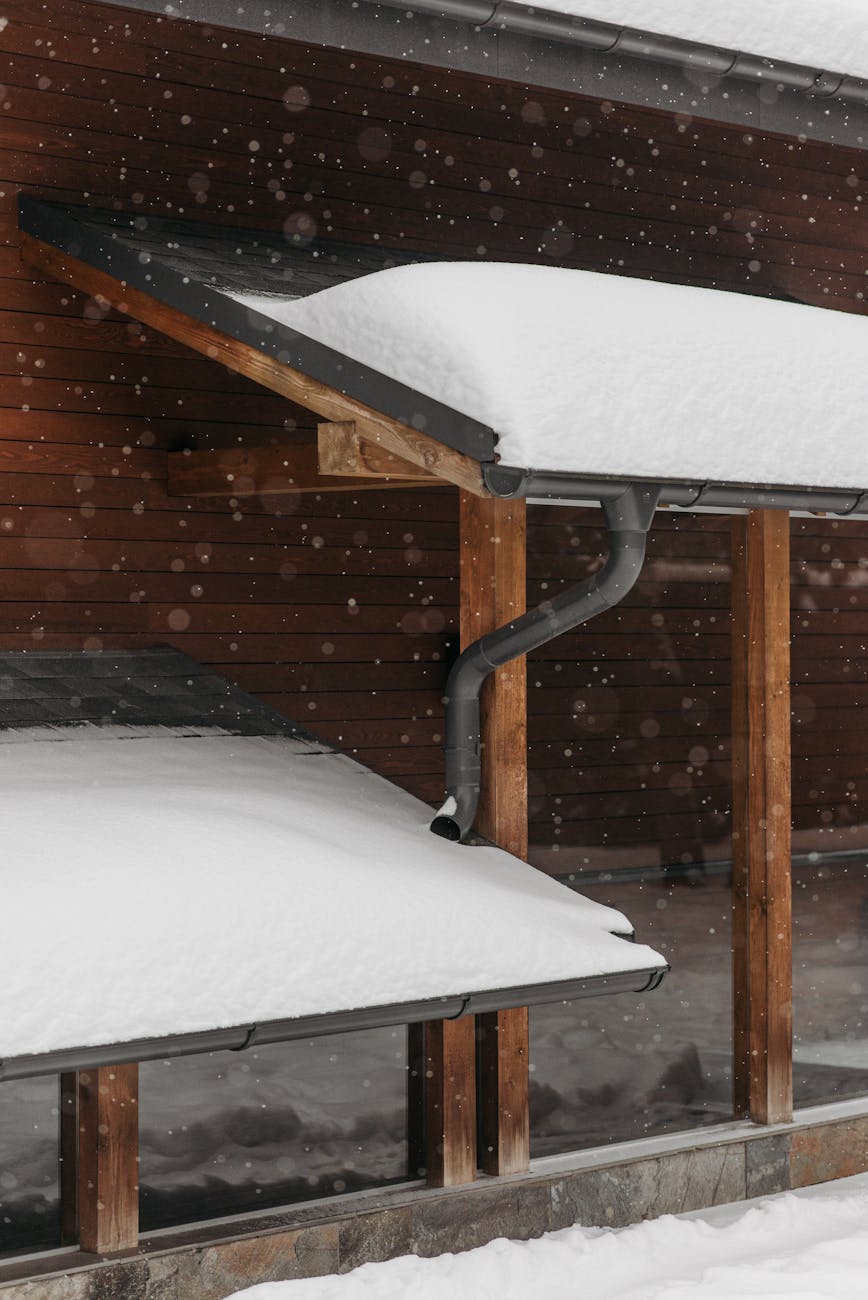 a white snow covered roofs during winter Everything You Need to Know About Gutter Maintenance in a Nutshell