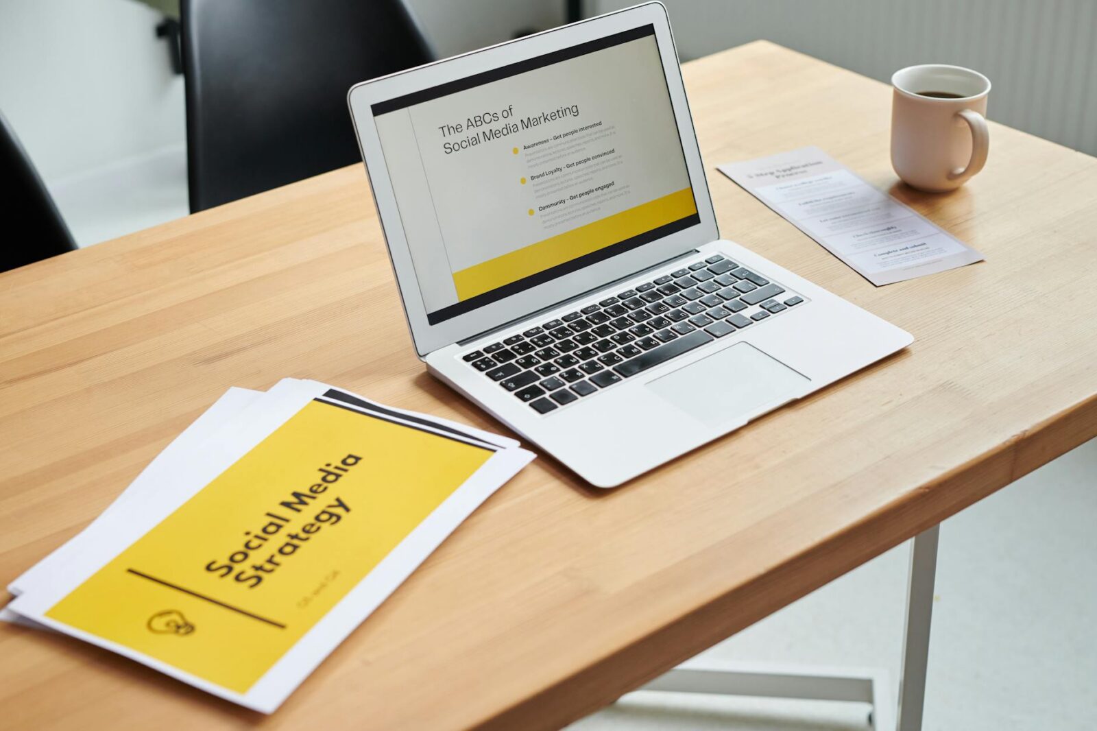 close up shot of a laptop beside paper documents How To Build Your Trade Firm's Online Presence