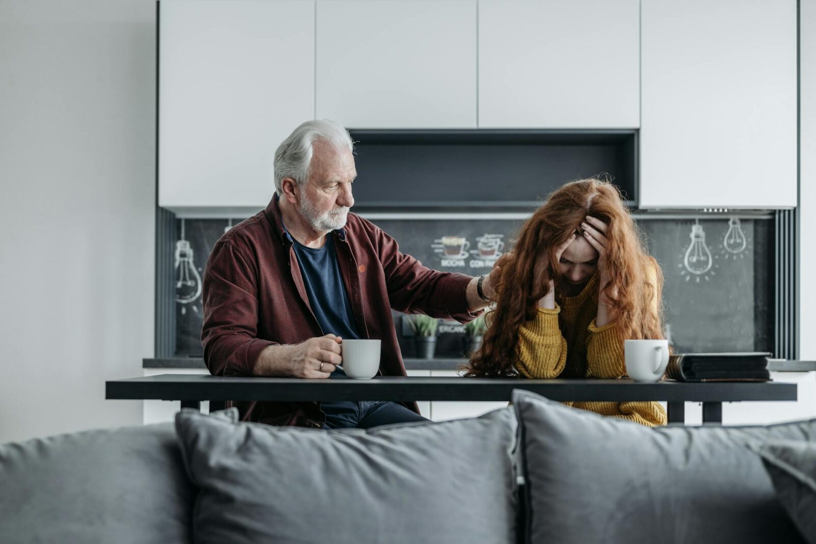man and woman sitting at the table How to Survive When You're Struggling Financially