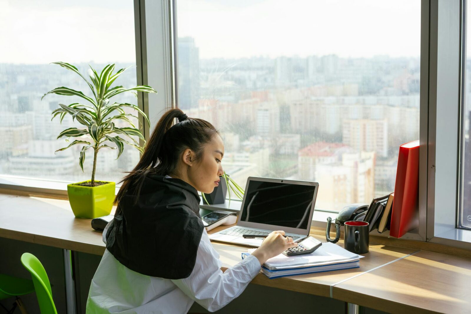 a woman working on the window counter How to Protect Your Money: 5 Habits for Long-Term Wealth