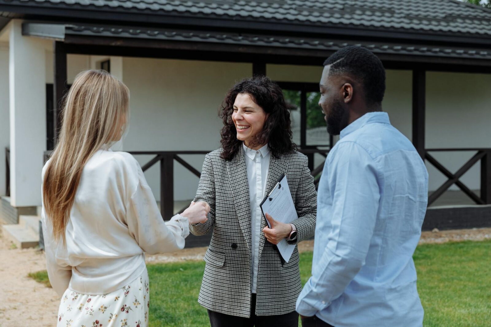 a man looking at the woman shaking each others hands How to Choose the Perfect Location to Invest in Real Estate
