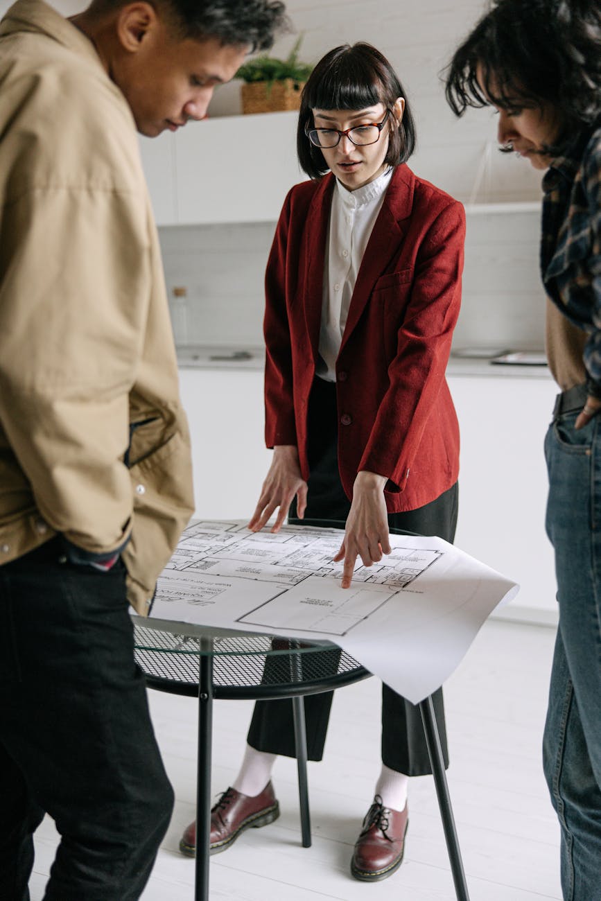 real estate agent showing sketch to costumers 6 Real Estate Metrics All Pro Investors Track
