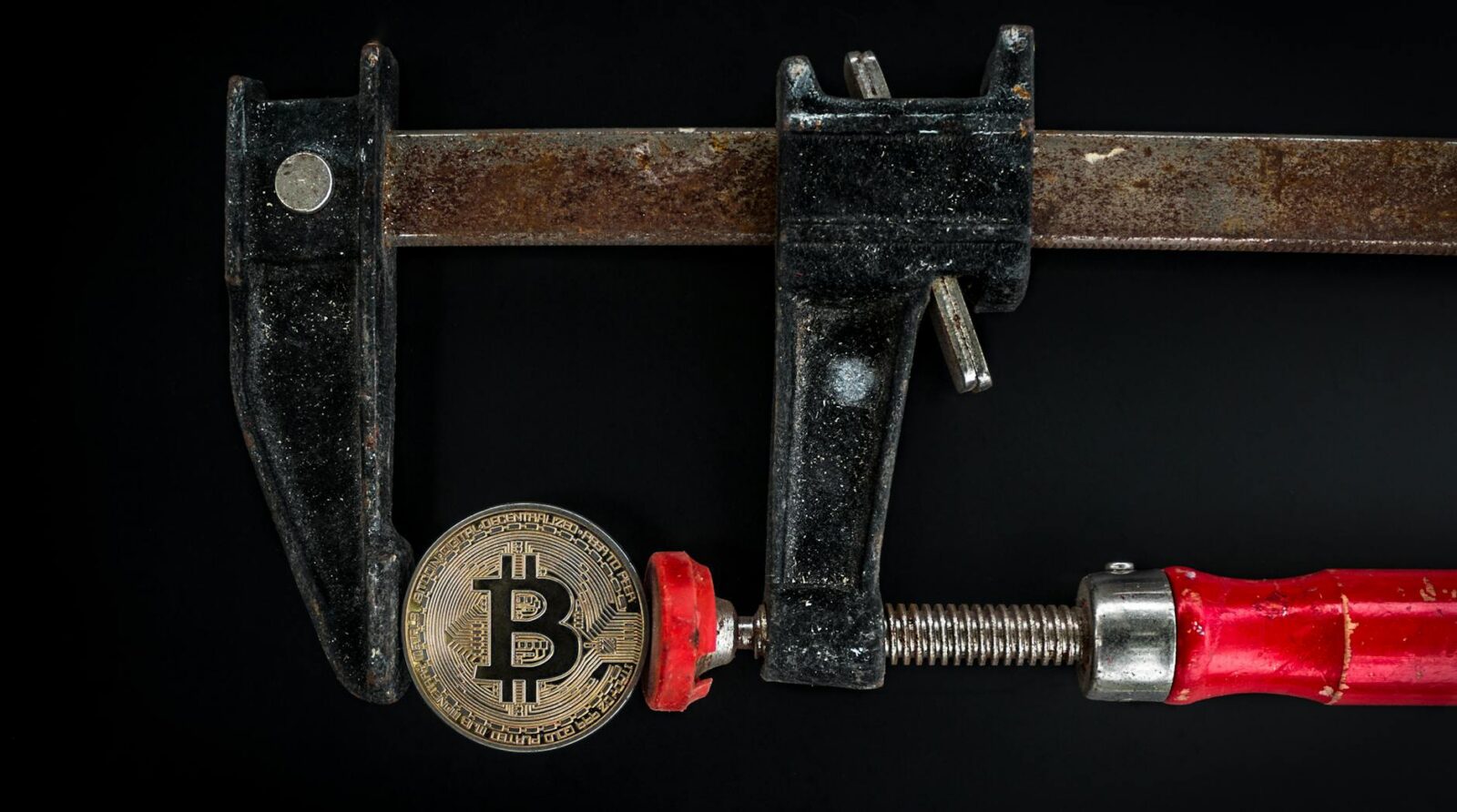 black and red caliper on gold colored bitcoin Challenges of Cryptocurrency Operations in Enterprises and Solutions for Smooth Crypto Integration