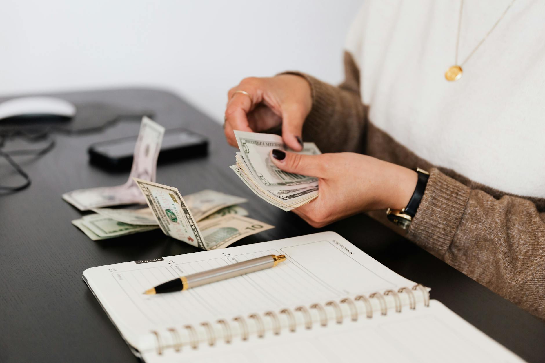 person counting cash money How To React When Health Issues Threaten Your Finances