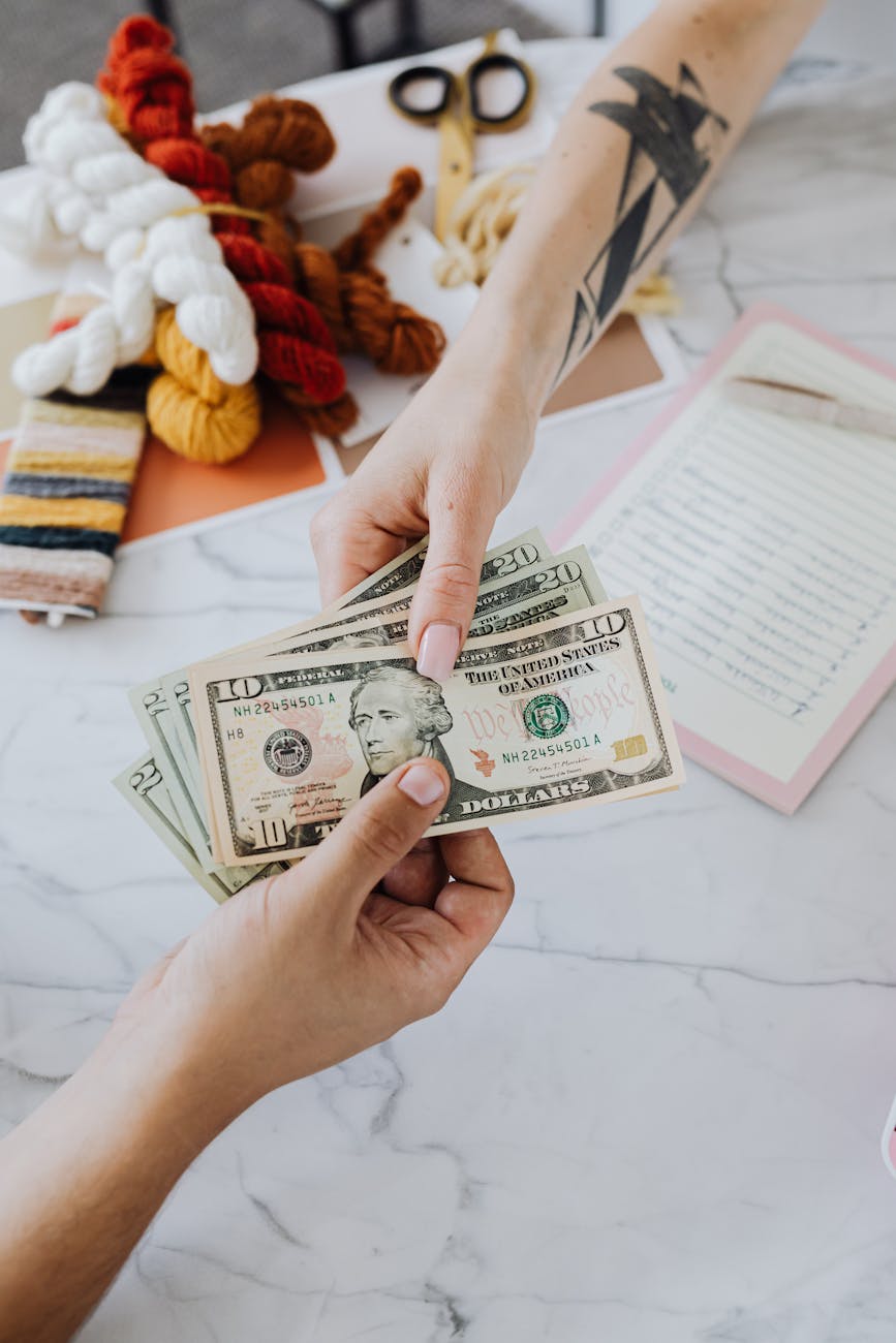 hands exchanging dollars Unique Money Moves: Beginner-Friendly Investment Strategies That Work