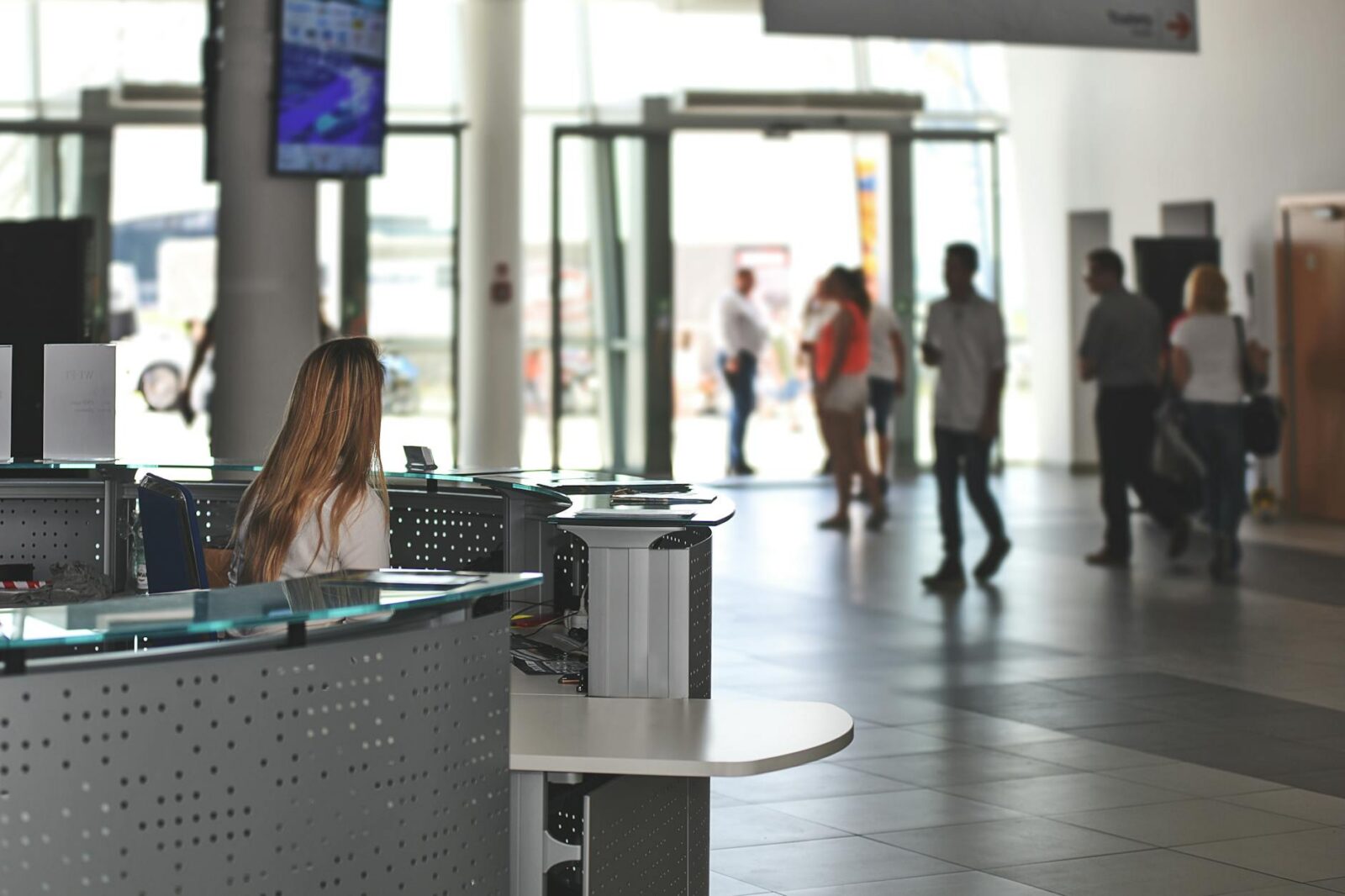 white sitting behind counter under television Top Commercial Real Estate Investment Strategies: Upgrades That Maximize ROI