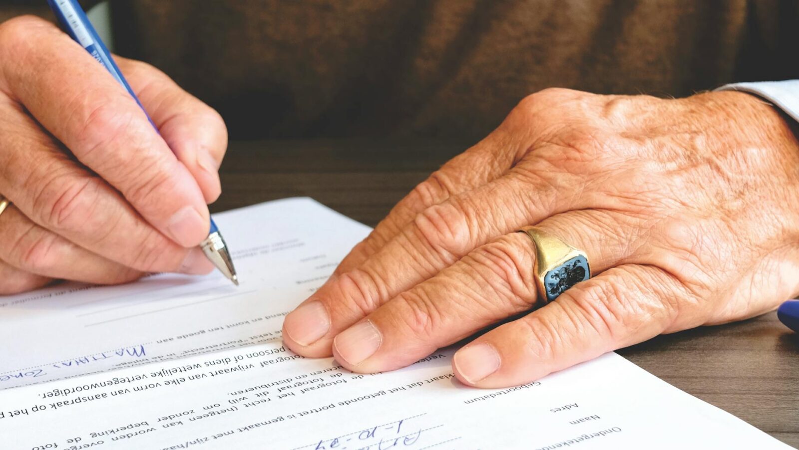 person signing document paper When to Hire an Attorney: Legal Guidance for Life’s Unexpected Moments
