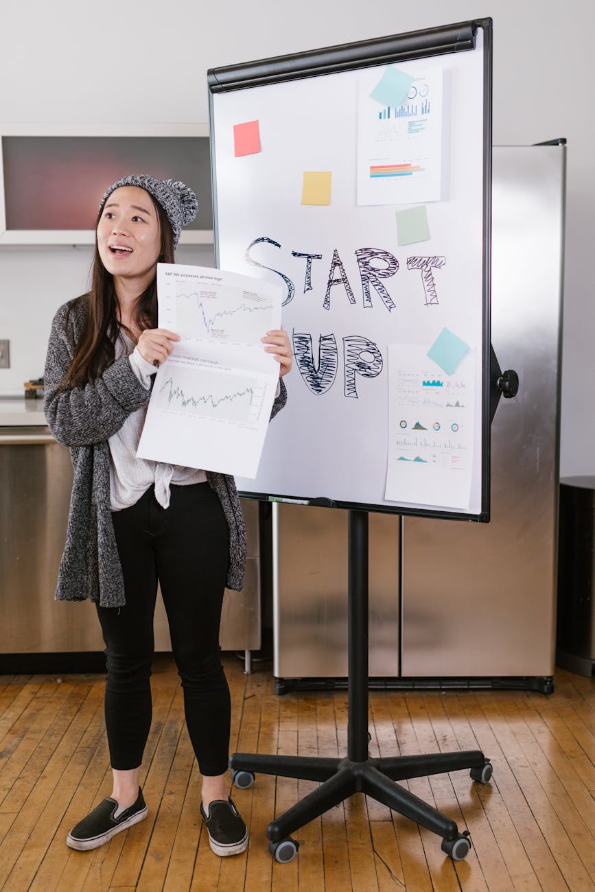 woman in gray coat holding white printer paper How to Invest in Your Business