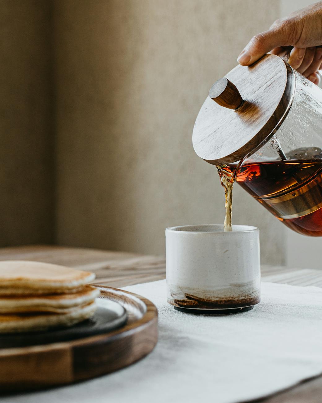 person pouring coffee How to Set Up a Kitchen From Scratch: STR Hosts & New Homeowners
