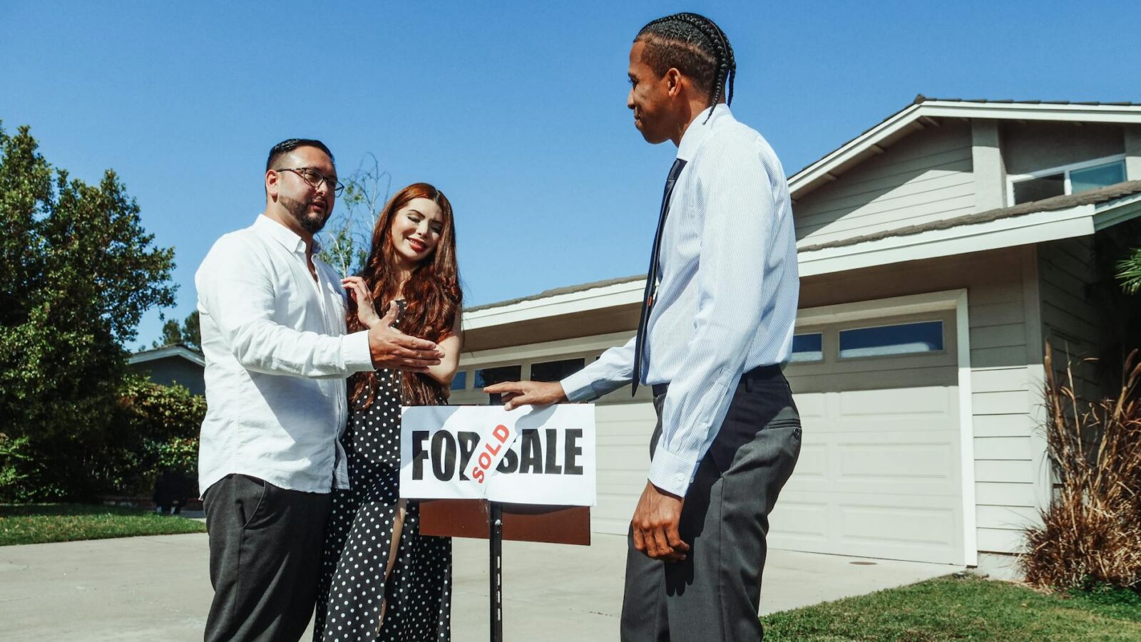 man and woman standing beside an agent Home Selling Mistakes That Cost You—And How to Avoid Them