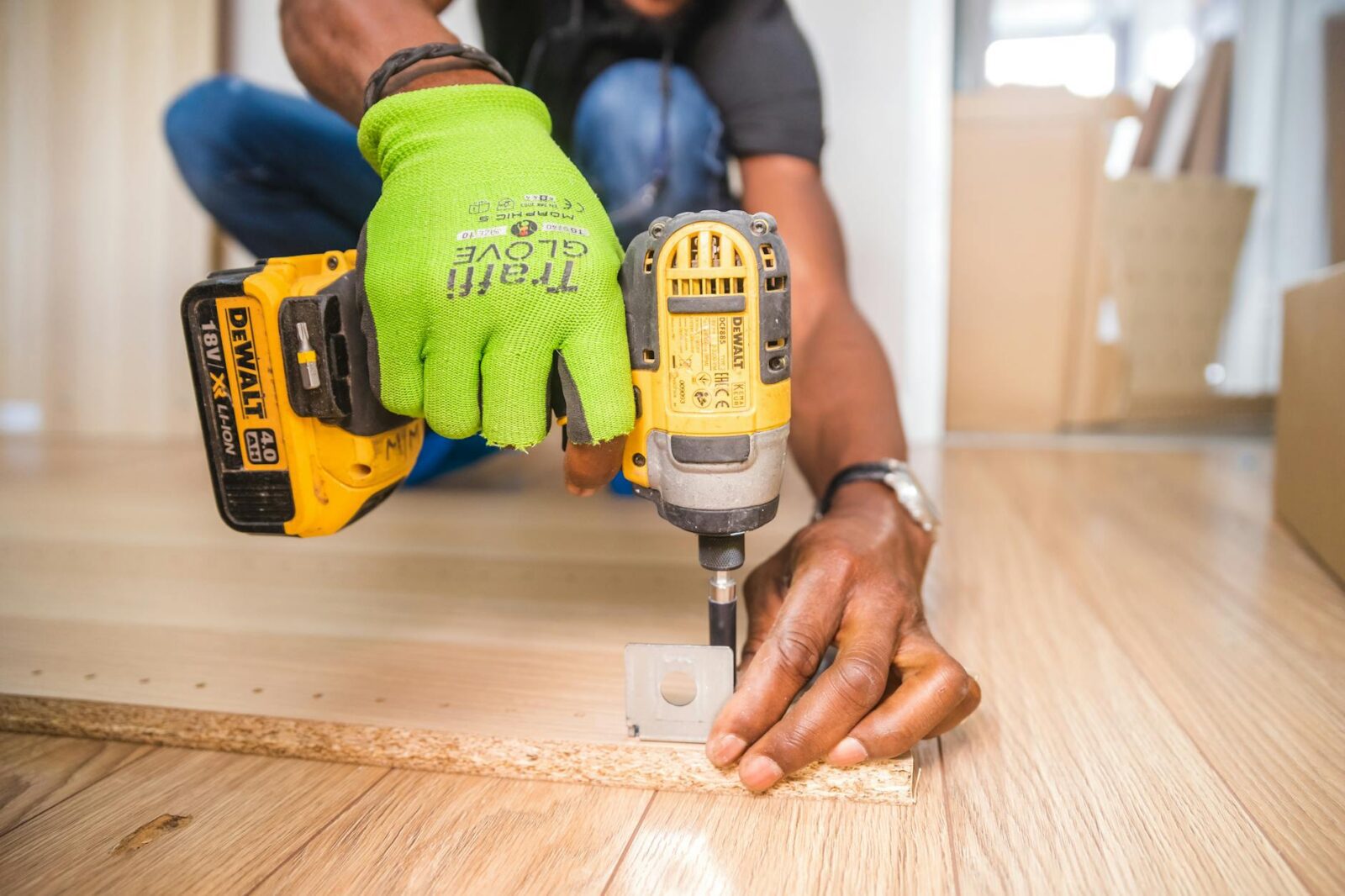 person using dewalt cordless impact driver on brown board DIY Disasters and How to Avoid Them