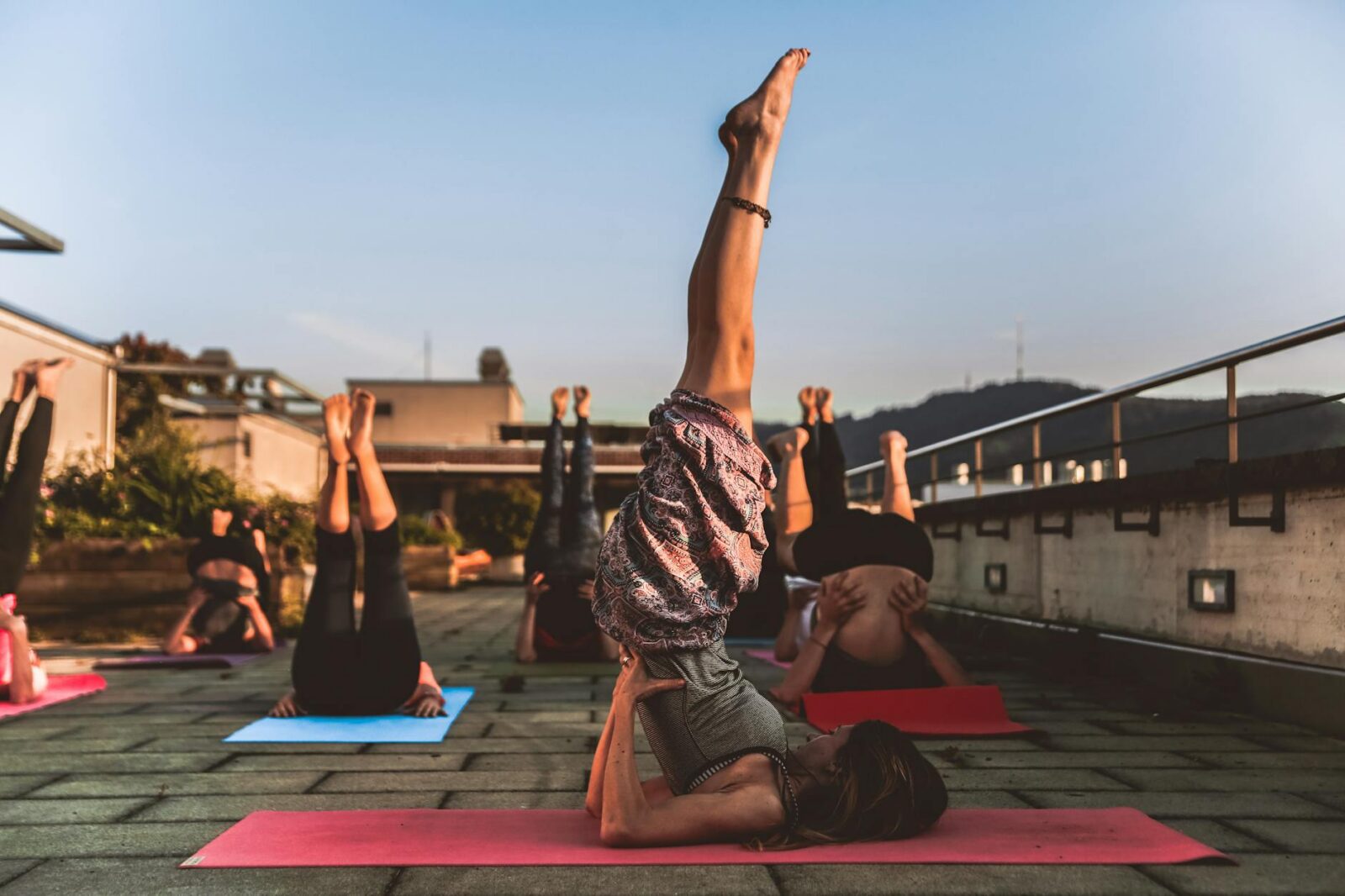 group of women lying on yoga mat under blue sky The Ultimate Guide to Yoga, Healing, and Tools to Support Your Journey