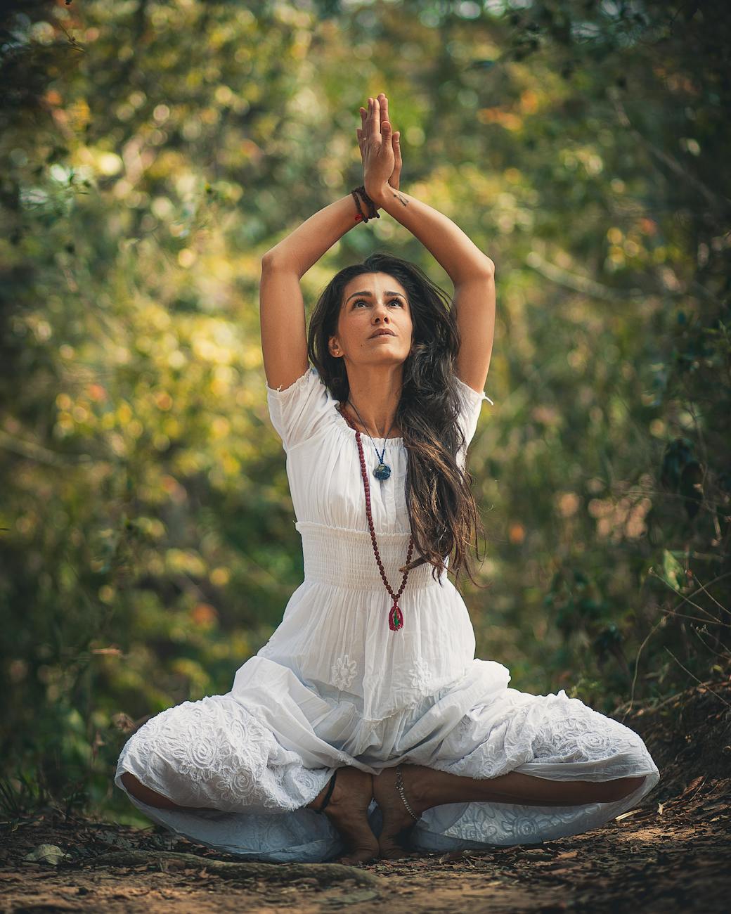 woman squatting on ground while raising both hands The Ultimate Guide to Yoga, Healing, and Tools to Support Your Journey