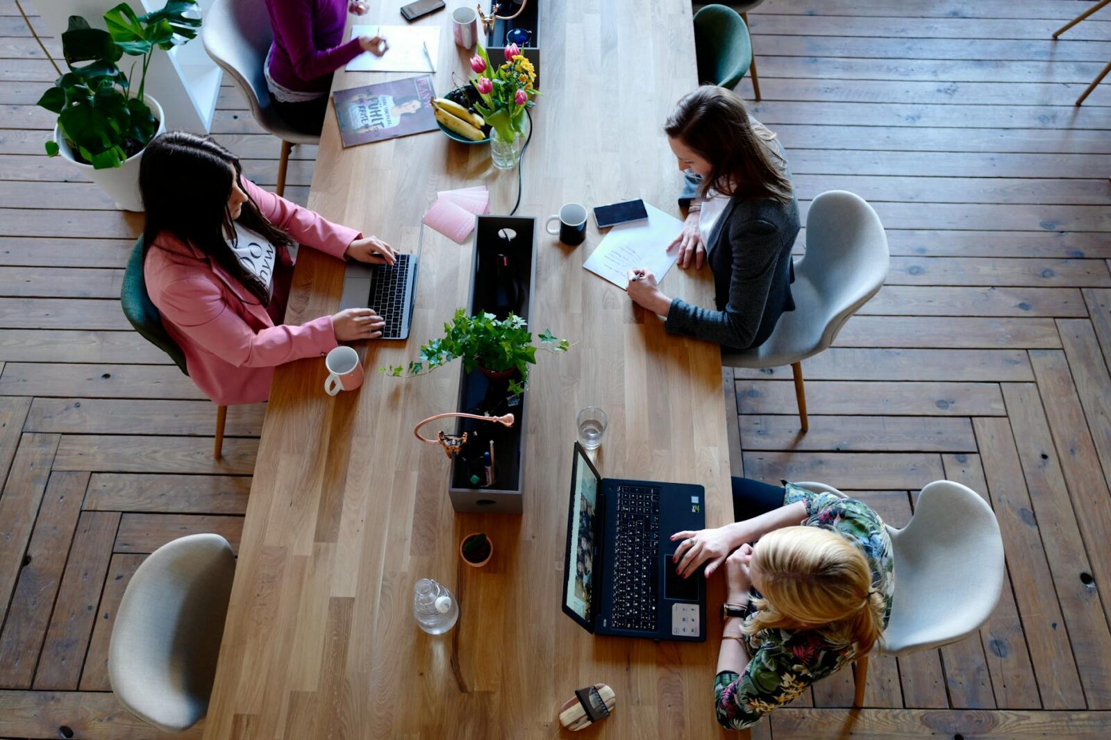 three woman sitting on white chair in front of table Rethinking Your Career Path? How to Start Working in Real Estate
