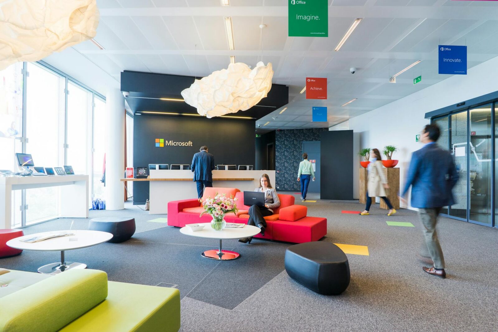 people near white counter desk When To Update Your Business Office Design