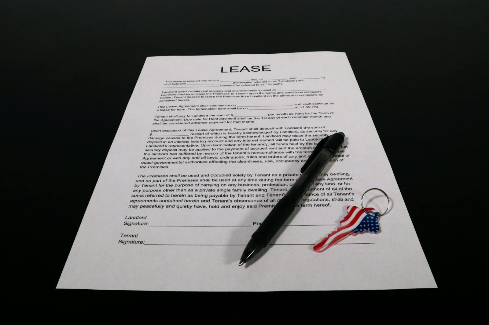 lease agreement document with pen and keychain Landlord Diaries: Is Passive Income Ever Really Passive?