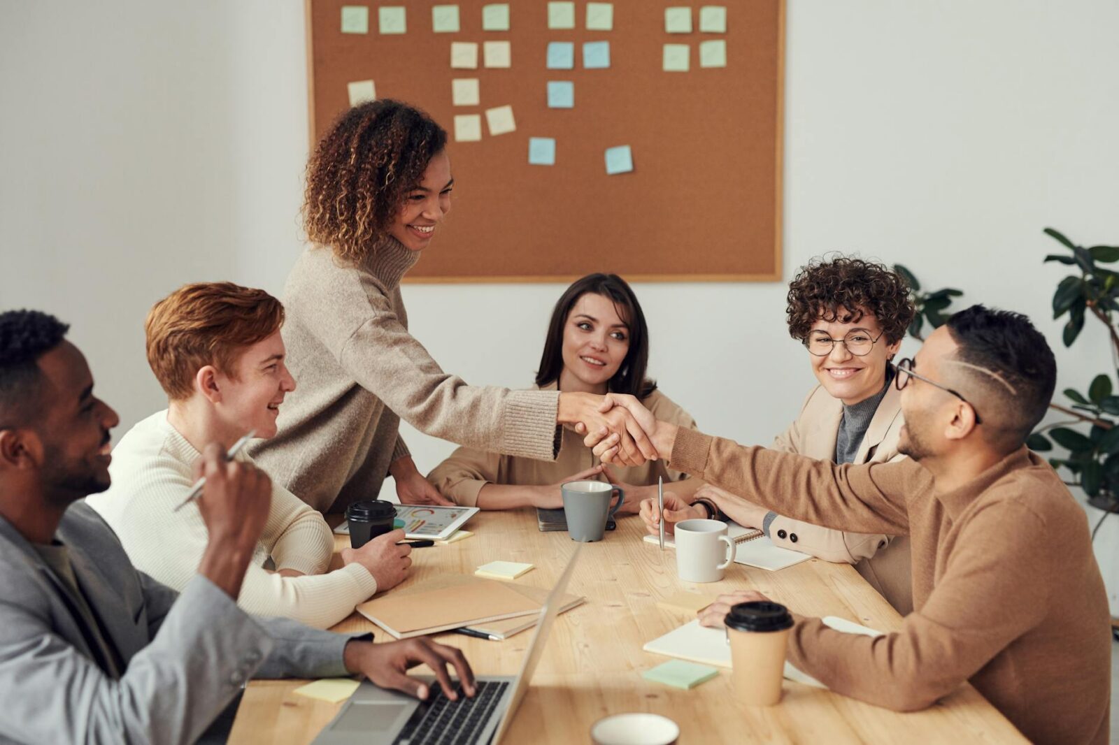colleagues shaking each other s hands Collaboration: The Secret to Saving Money Without Sacrificing Quality