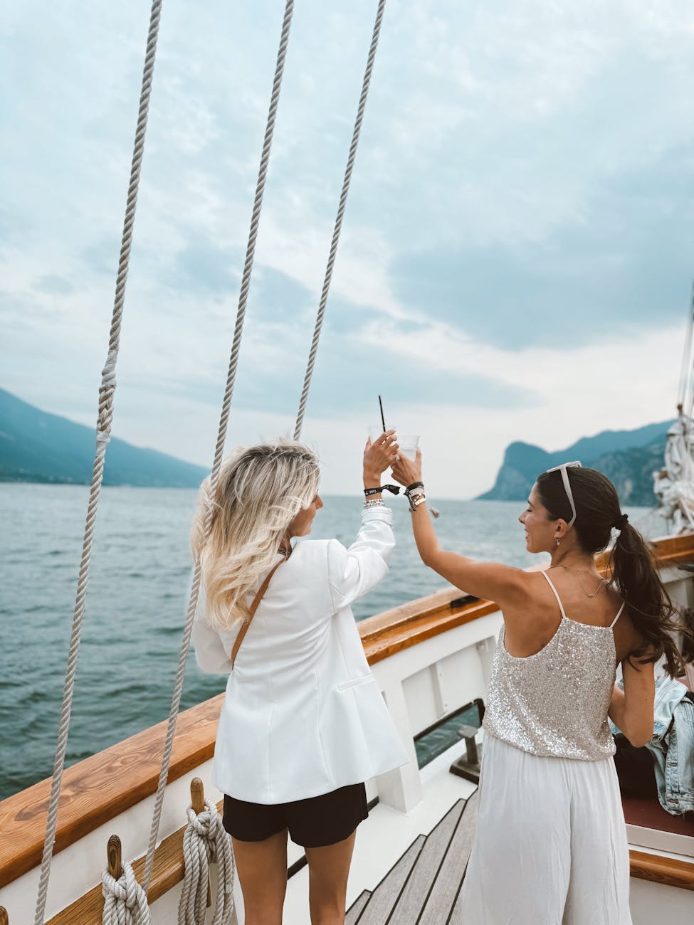 elegant women enjoying yacht cruise on italian lake Add Luxury to Your Next Vacation