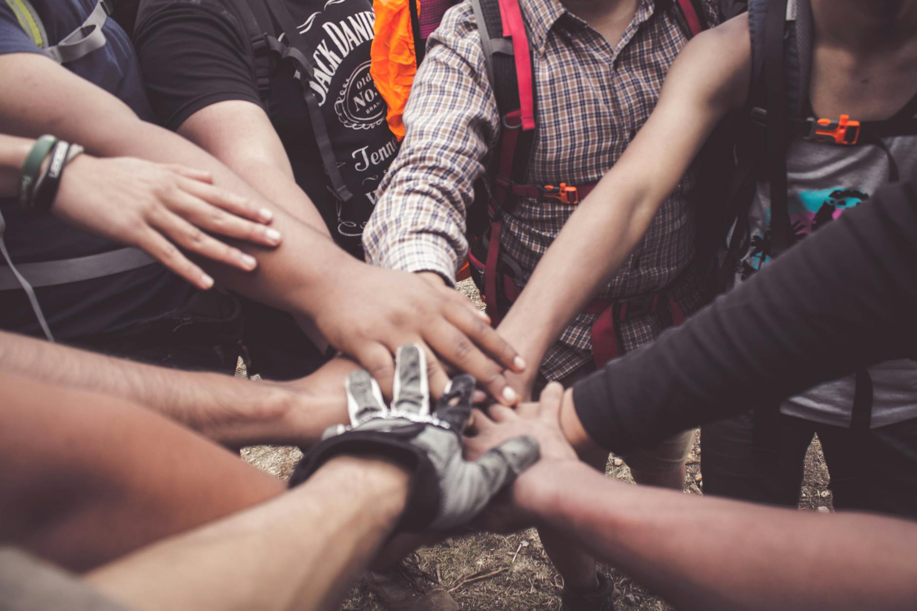 people doing group hand cheer Collaboration: The Secret to Saving Money Without Sacrificing Quality