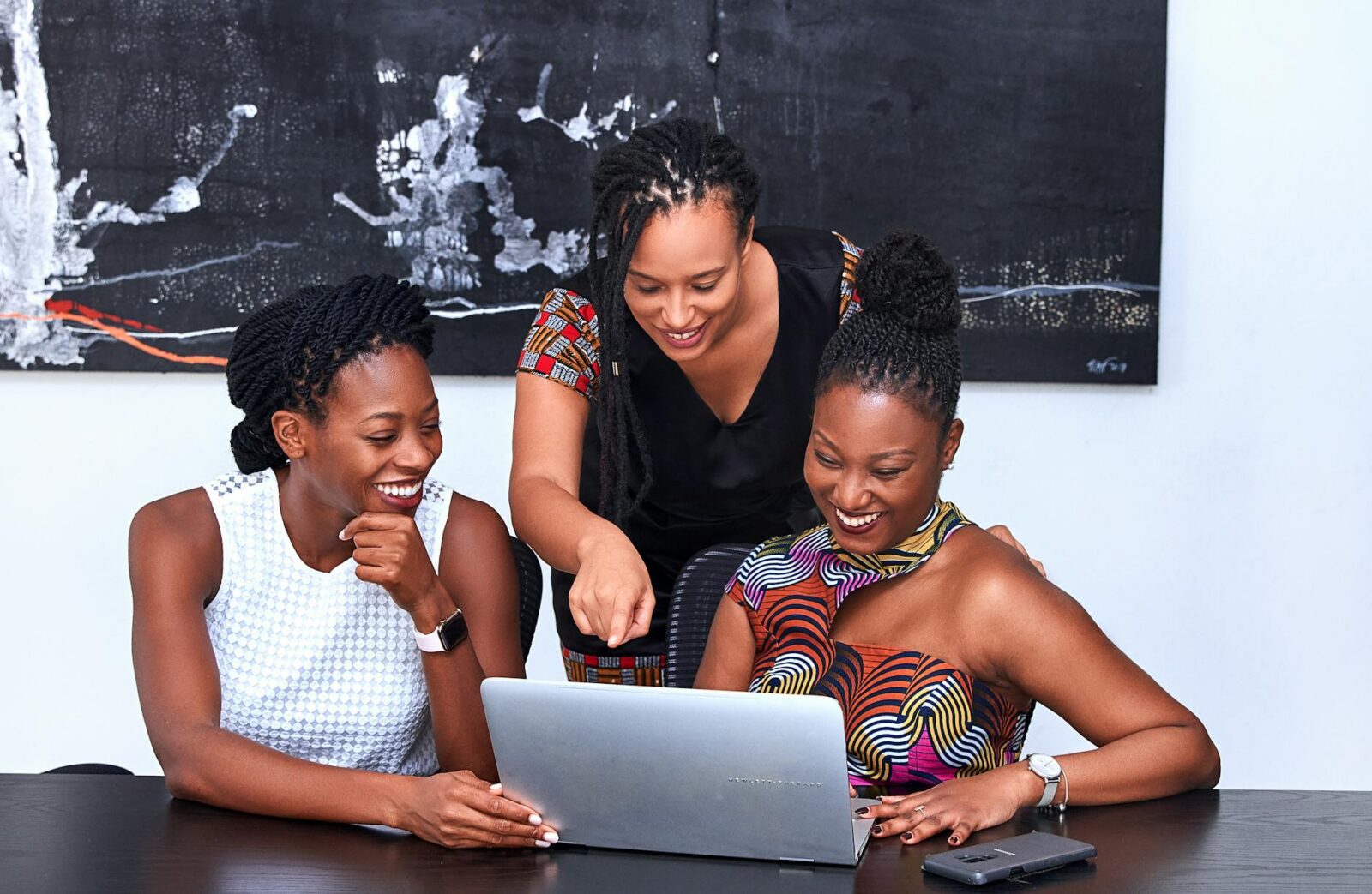 three women looking at the computer Collaboration: The Secret to Saving Money Without Sacrificing Quality