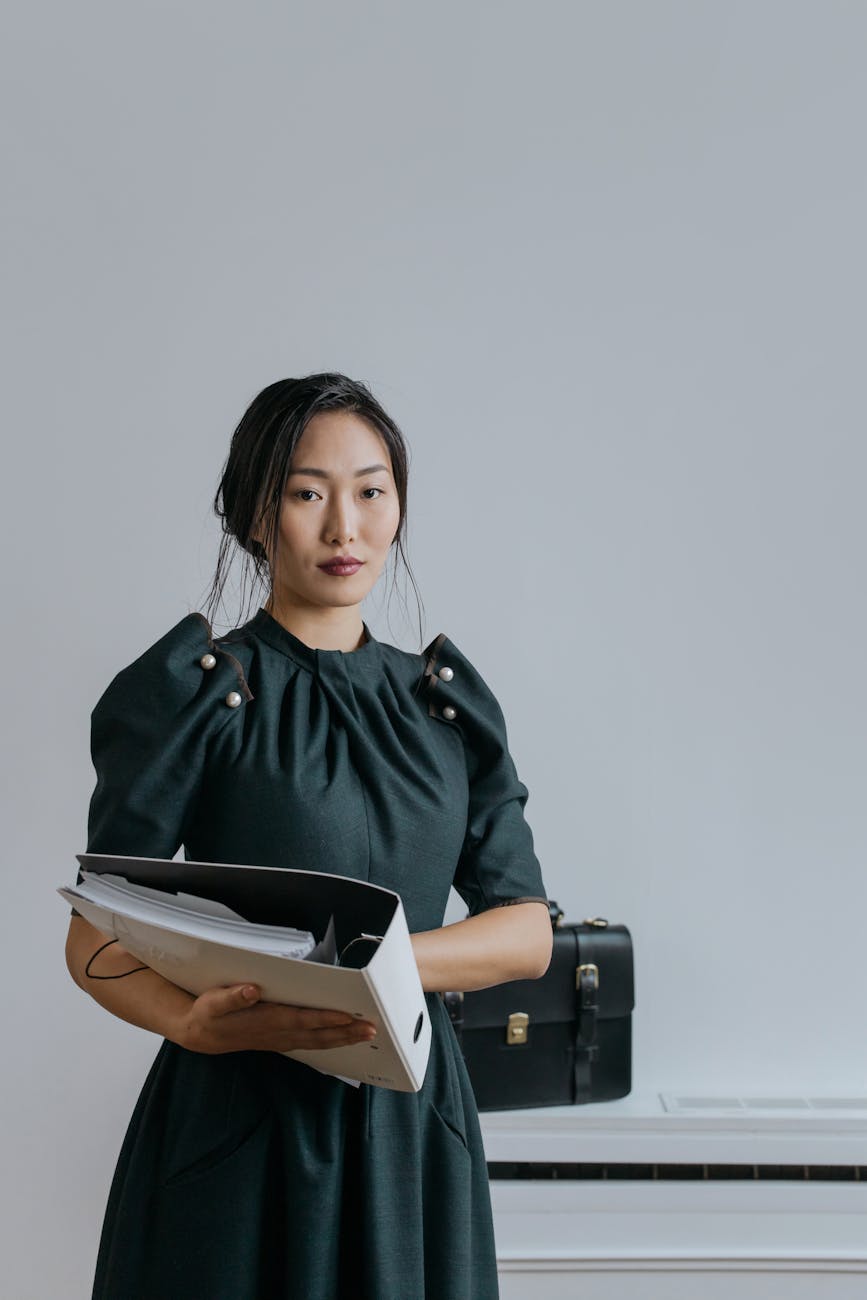 a woman in black dress holding an organizer Rethinking Your Career Path? How to Start Working in Real Estate