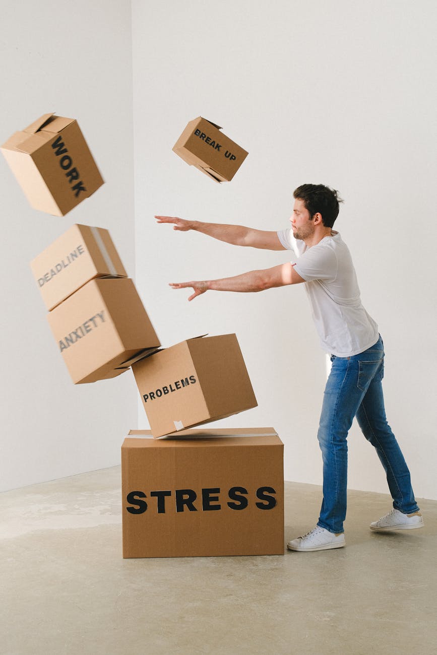 man falling carton boxes with negative words The Power of the Exit: Learning to Leave What’s No Longer for You