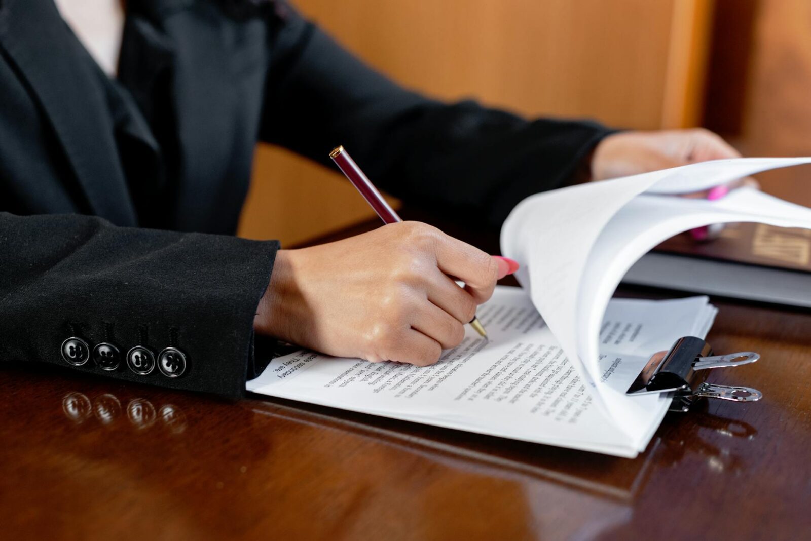 a person writing on the document 3 Stressful Life Situations When You Need a Lawyer (and Why It Pays Off)