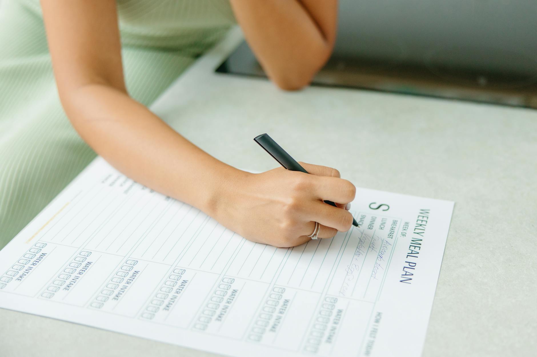 a woman making a meal plan Shaving Dollars From Your Grocery Bills: Shopping Tips to Save Money