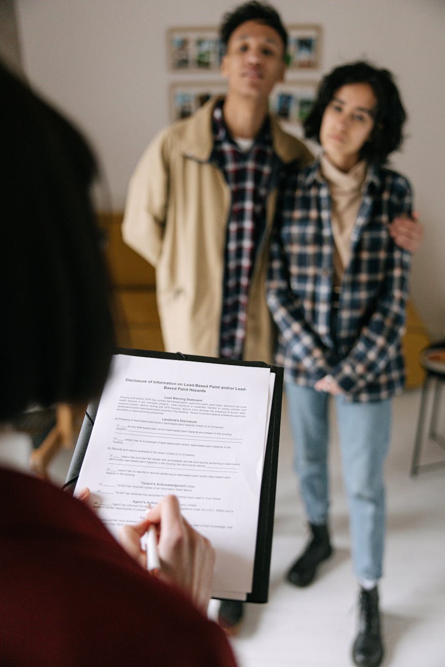 couple talking with real estate agent Landlord Diaries: Is Passive Income Ever Really Passive?